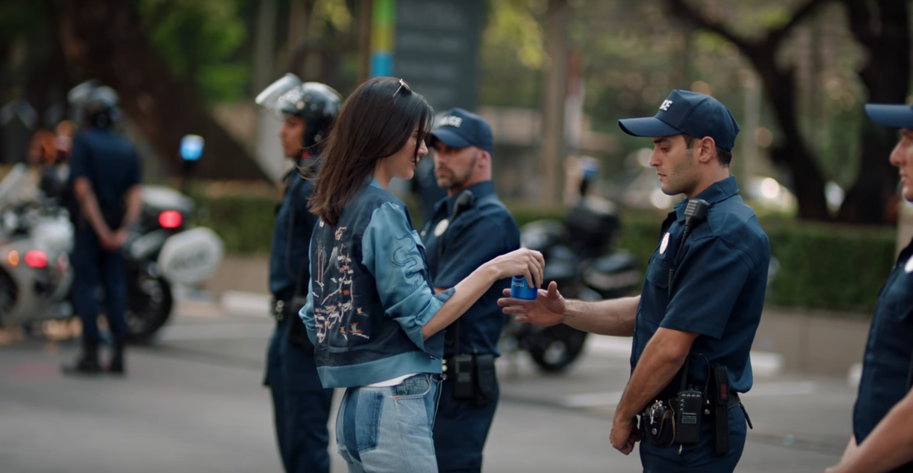 We wish solving issues was as easy as Kendall Jenner giving police a can of Pepsi